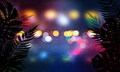 Empty scene background, abstract background with multicolored bokeh and neon lights. Silhouettes of tropical leaves