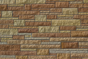 Attractive kasota limestone brick wall background with bricks in varying shades of brown