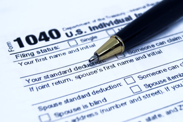 Income tax form with black pen
