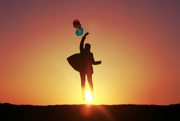 girl jumping with balloons at sunset, colorful balloons, incredible sunset sky flying into the sky