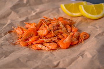 Shrimps with lemons on craft paper