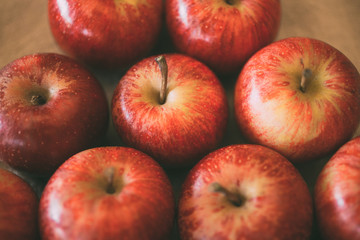 Red fresh apples as background. Close up view of heap of delicious apples as texture and background. 