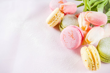 Classic colorful macarons. Six pink, yellow and green macaron cookies top view copy space