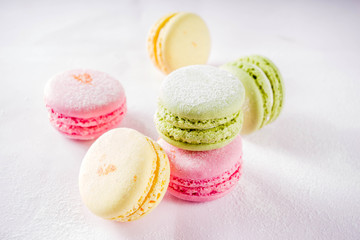 Classic colorful macarons. Six pink, yellow and green macaron cookies top view copy space