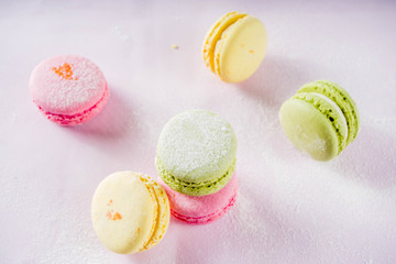 Classic colorful macarons. Six pink, yellow and green macaron cookies top view copy space