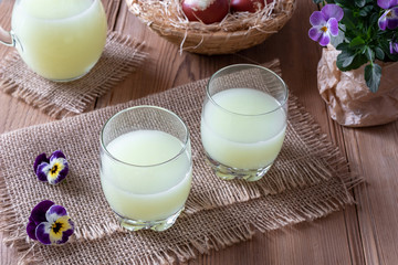 Fresh whey in two glasses and a jug