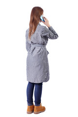 Fototapeta premium back view of a woman talking on the phone.