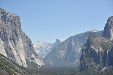 Fototapeta premium Yosemite National Park, CA., U.S.A. June 26, 2017. Panorama view of Yosemite Valley from the tunnel showing El Capitan, Half-dome, Bridalveil Falls.