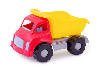 Vintage dump truck isolated on white background with shadow reflection. Plastic child toy on white backdrop. Dump tipper truck lorry construction vehicle. Children's toy. Kid's plaything.