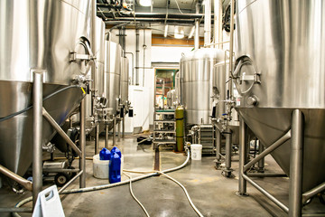 A Modern Beer Factory. Rows of steel tanks for beer fermentation and maturation