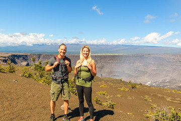 The Hiking couple seeing volcano national park from crater on the caldera Halemaumau around Hawaii volcanoes national park