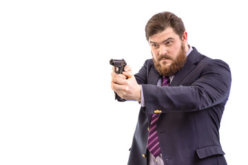 Portrait of a big handsome serious bearded business man with gun in dark suit and bright blue tie, isolated on white