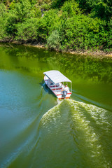 MONTENEGRO, CRNOJEVIC RIVER - JUNE 08/2017: motorboat carries tourists to the scenic spots of the beautiful river.