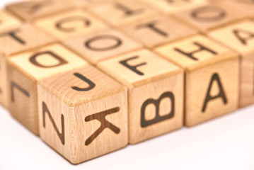 wooden cubes on a white background and various chaotic letters