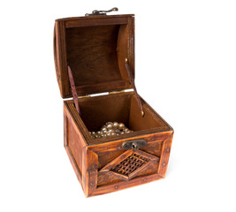 Antique jewelry trunk full with pearls, open cover. Isolated on white background