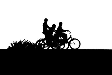 Fototapeta na wymiar Three boys on bikes silhouette