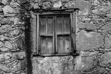 old wooden windows in stone facade