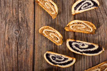 poppy and walnut roll cakes, old wood table, christmas and easter traditional east european dessert