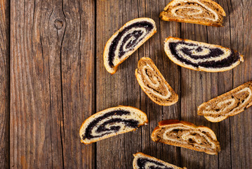 poppy and walnut roll cakes, old wood table, christmas and easter traditional east european dessert