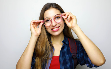 Portrait of a casual student woman in glasses looking at camera isolated on a white background