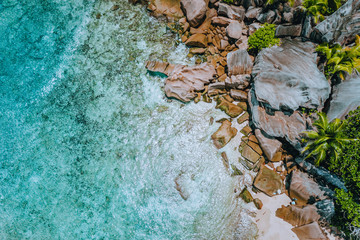 Aerial drone landscape of seychelles tropical paradise anse cocos beach with pure crystal clear turquoise water and bizarre granite rocks. La Digue Island