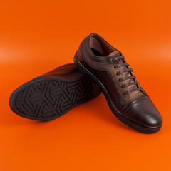 Brown Sneakers Footwear on Orange background