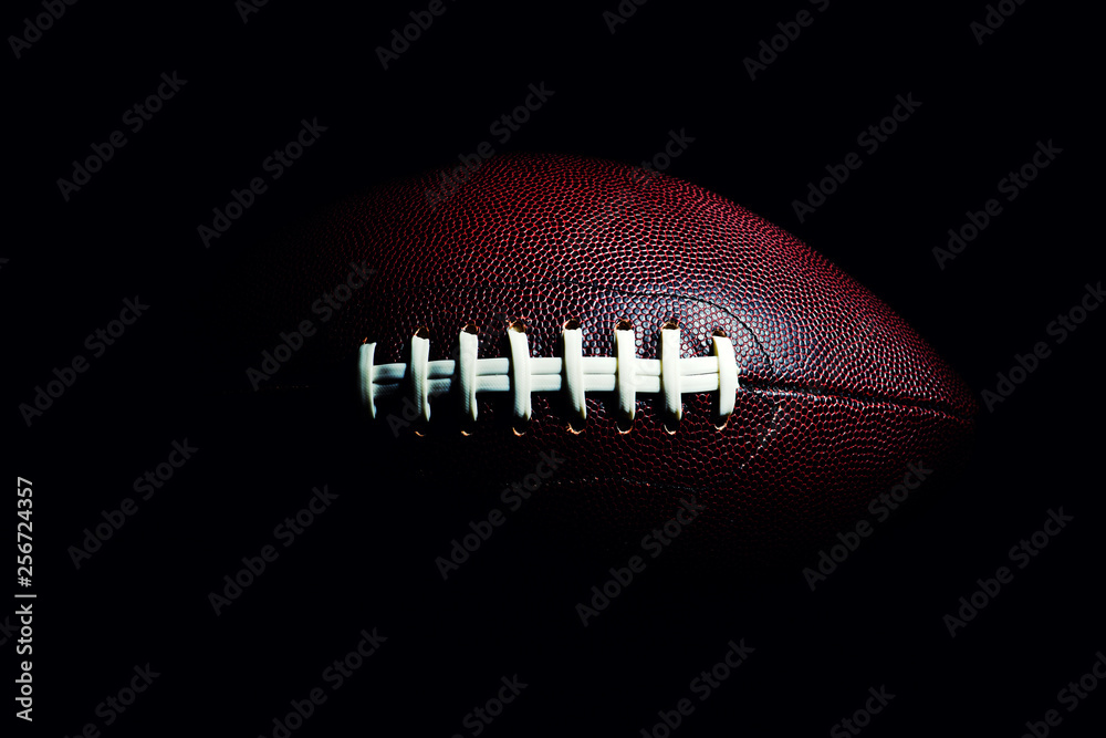 Wall mural American football ball isolated on black background