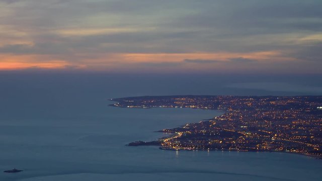 Aerial night view of Bugio Fort, Oeiras Carcavelos Sintra Paco de Arcos and Lisbon, with Sintra mountains in the background and city lights.