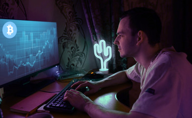 a man works at a computer exchange rates bitcoin mining