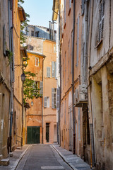 Fototapeta na wymiar Narrow street in the charming old city of Aix-en-Provence, France