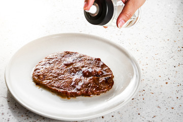 Spraying oil on the steak