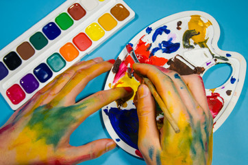 painter hands and gouache colors