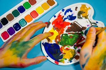 Fototapeta na wymiar painter hands and gouache colors