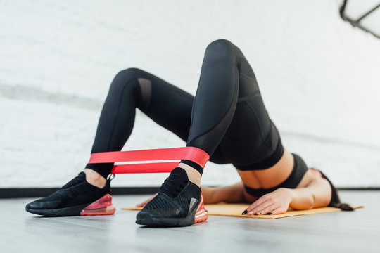 Close up of athletic woman in squat together in gym.