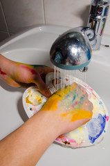 washing paint palette with water