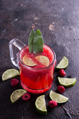 Red raspberry drink with salvia and lime composition.