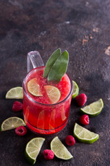 Hot raspberry drink with salvia leaf.