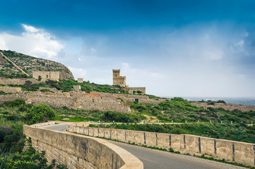 Fototapeta na wymiar Malta: Scenic road to Ghar Lapsi tower with hilly landscape and sea