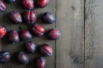 plums on black wooden table