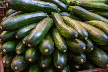 A pile of zucchini (courgettes) for sale at a market in France