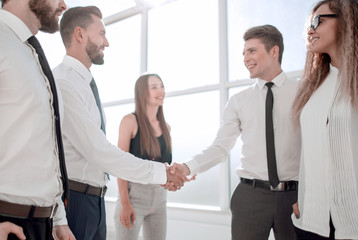 handshake between business colleagues in the office