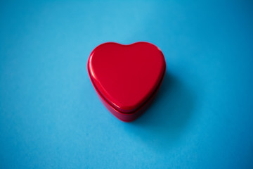 Closeup of red heart on the blue background.