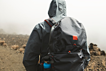 A hiking Tourist admiring climb Mauna kea volcano on the Big Island of Hawaii.