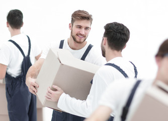 Portrait of movers holding box smiling isolated on white backgro