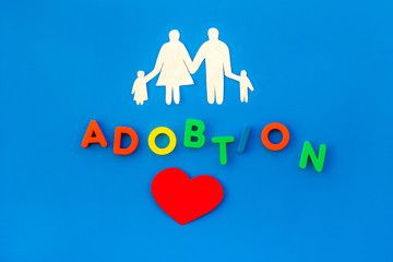 adoption copy and figures on blue background top view