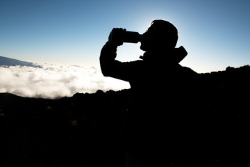 A Man on peak of mountain with water bottle