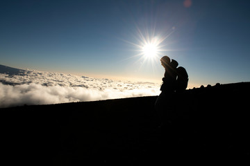 A hiking Tourist admiring breathtaking view of Mauna kea volcano on the Big Island of Hawaii.