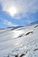 Fototapeta na wymiar Snow mountain sunshine and clouds