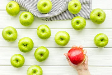 green apples for organic summer food pattern on light wooden background top view