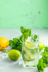 Mojito cocktail with lime and mint in highball glass